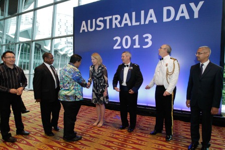 Staff of the Australian High Commission (in front of the backdrop) greeting guests as they arrive for the Australia Day 2013 reception.